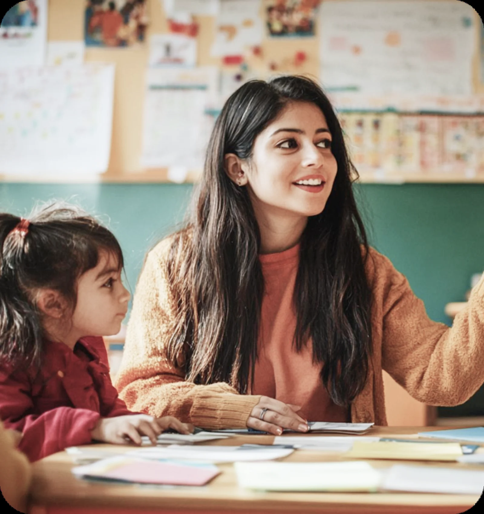 A teacher working with a student in class